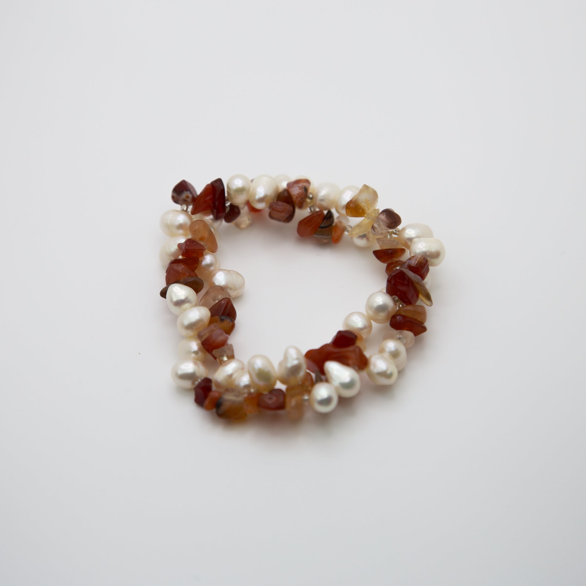 Amber and Pearl Bracelet on a brown bracelet display piece