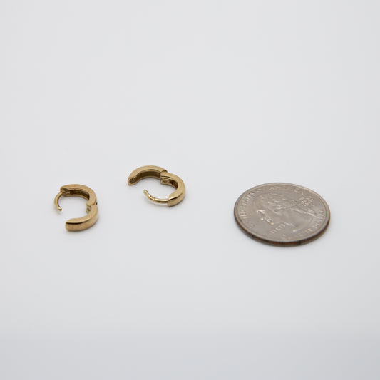 14k Gold Mini Hoop Earrings next to a US quarter coin for sizing.