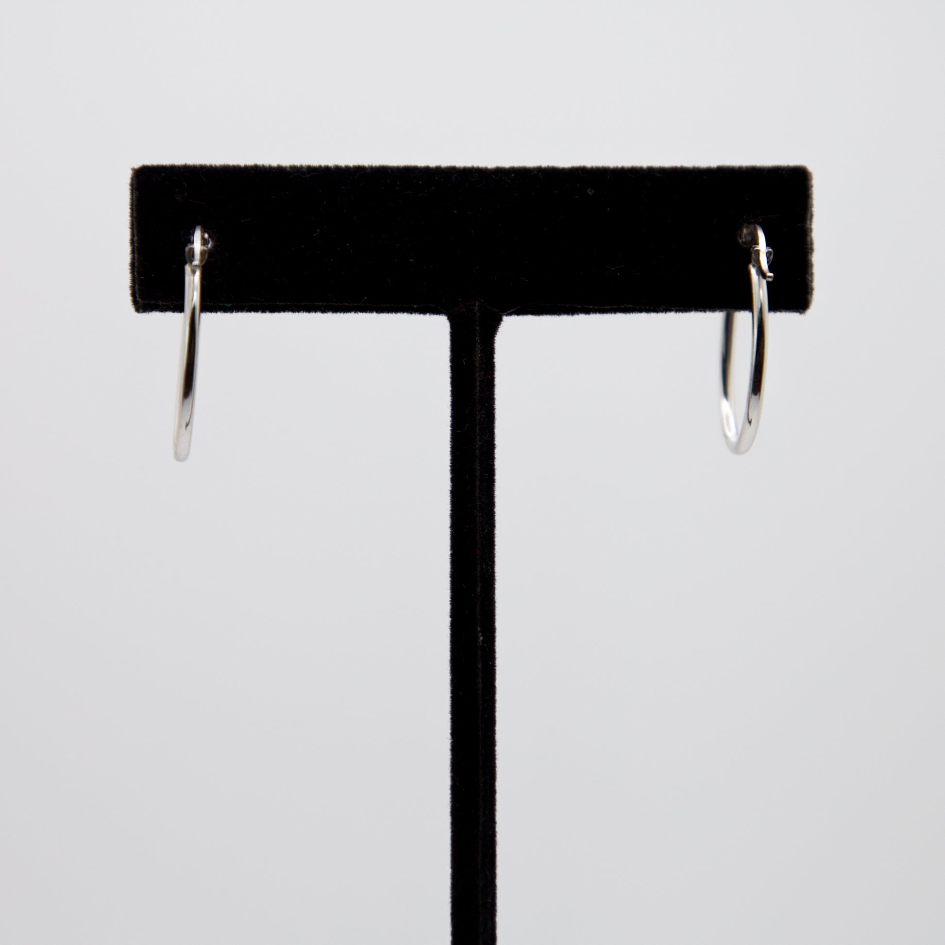 14k White Gold Hoops on a black earring stand.